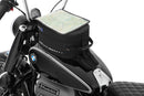 The mounting system is attached to the vehicle with minimal hand pressure and the tank bag can be quickly fastened to it. 
