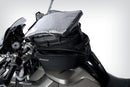 The mounting system is attached to the vehicle with minimal hand pressure and the tank bag can be quickly fastened to it. 