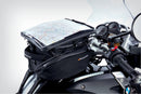The mounting system is attached to the vehicle with minimal hand pressure and the tank bag can be quickly fastened to it. 