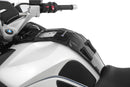 The mounting system is attached to the vehicle with minimal hand pressure and the tank bag can be quickly fastened to it. 