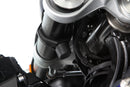 Limit and dampen the steering angle in the event of a fall, even before the standard steering stops are reached with full force
